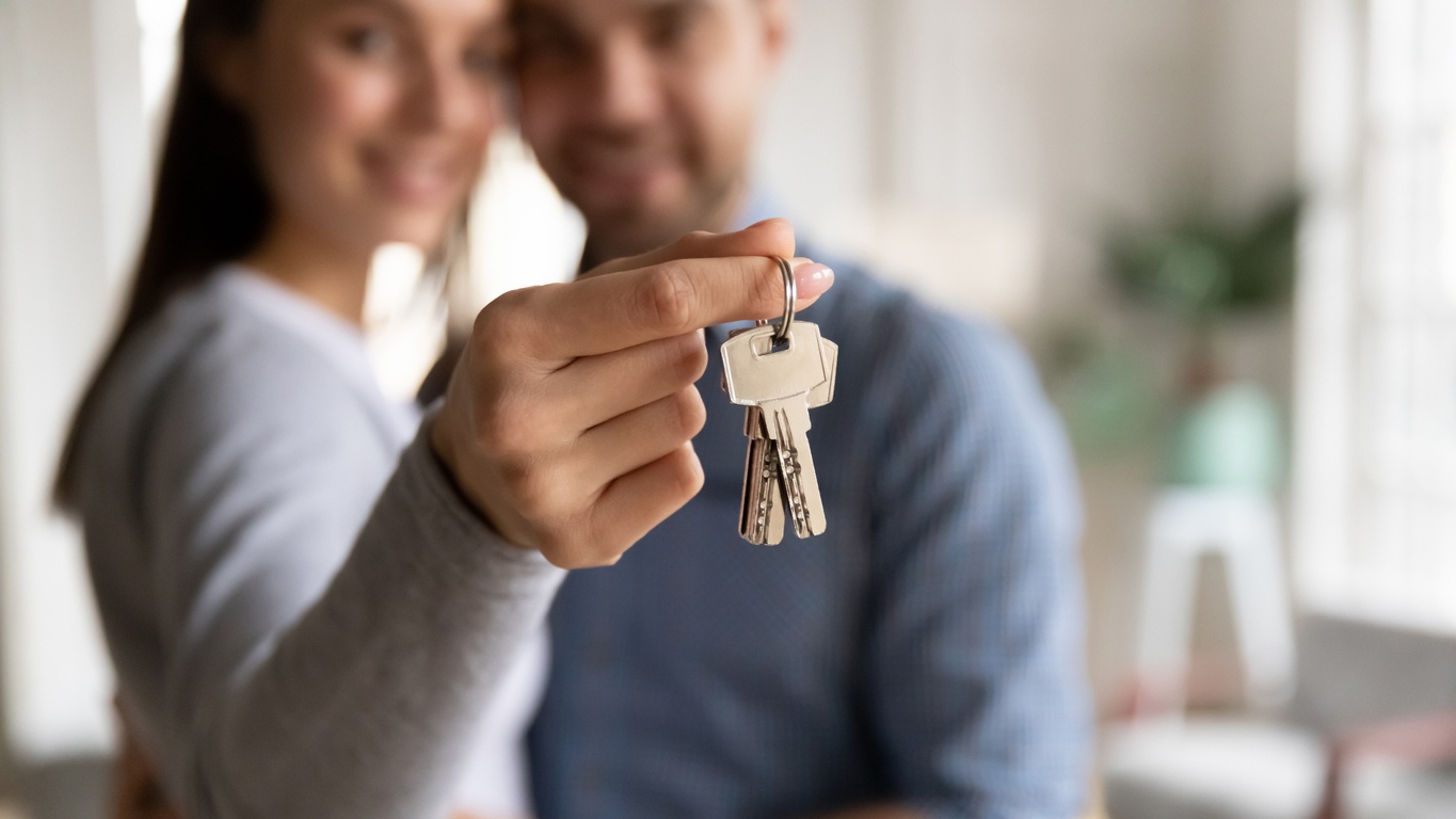 close-up-happy-young-woman-hugging-man-holding-keys